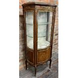 A good quality French serpentine vitrine cabinet with gilt metal mounts and inlaid panel to the