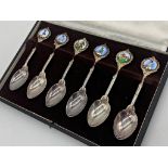 Cased set of six horse racing related silver crested spoons, each with applied enamel plaque, with