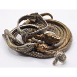 A box of metal jewellery modelled as snakes to include an articulated snake belt etc. Five items.