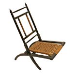 Edward William Godwin (1833-1886) - ebonised folding chair, with strung seat (back panel vacant),