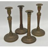 Two pairs of Georgian gun metal candle sticks, 26cm and 24cm (4)