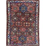 Good antique Persian rug, geometric medallion panels, deep red ground, 215 x 150cm