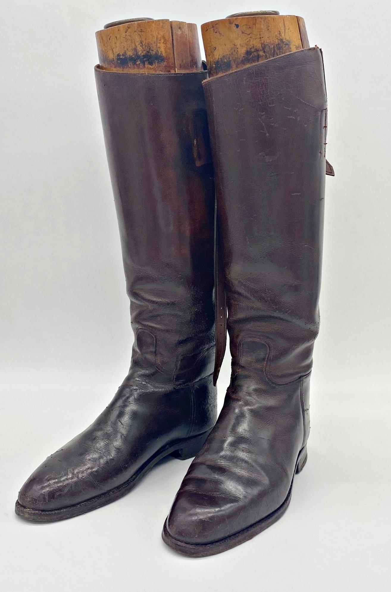 Good pair of leather riding boots with original trees with brass pull handles, 49cm high