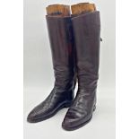 Good pair of leather riding boots with original trees with brass pull handles, 49cm high