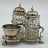 Victorian silver cruet on stand, two silver lidded cut glass bottles and small silver bowl, the