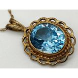 A 9ct gold mounted blue Topaz pendant with associated 9ct gold chain. Chain measures 48 cm long