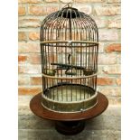 19th century cast wirework birdcage with fitted interior upon a mahogany lazy Susan, 67cm high