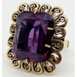 A 14ct gold vintage ring set with a large faceted amethyst stone, size M 1/2, 12.4 grams approx