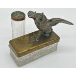 Pair of brass lidded glass dressing jars each set with applied embossed cat head decoration with