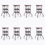 Set of 8 American factory stools, wooden tops on steel frames, 64cm high