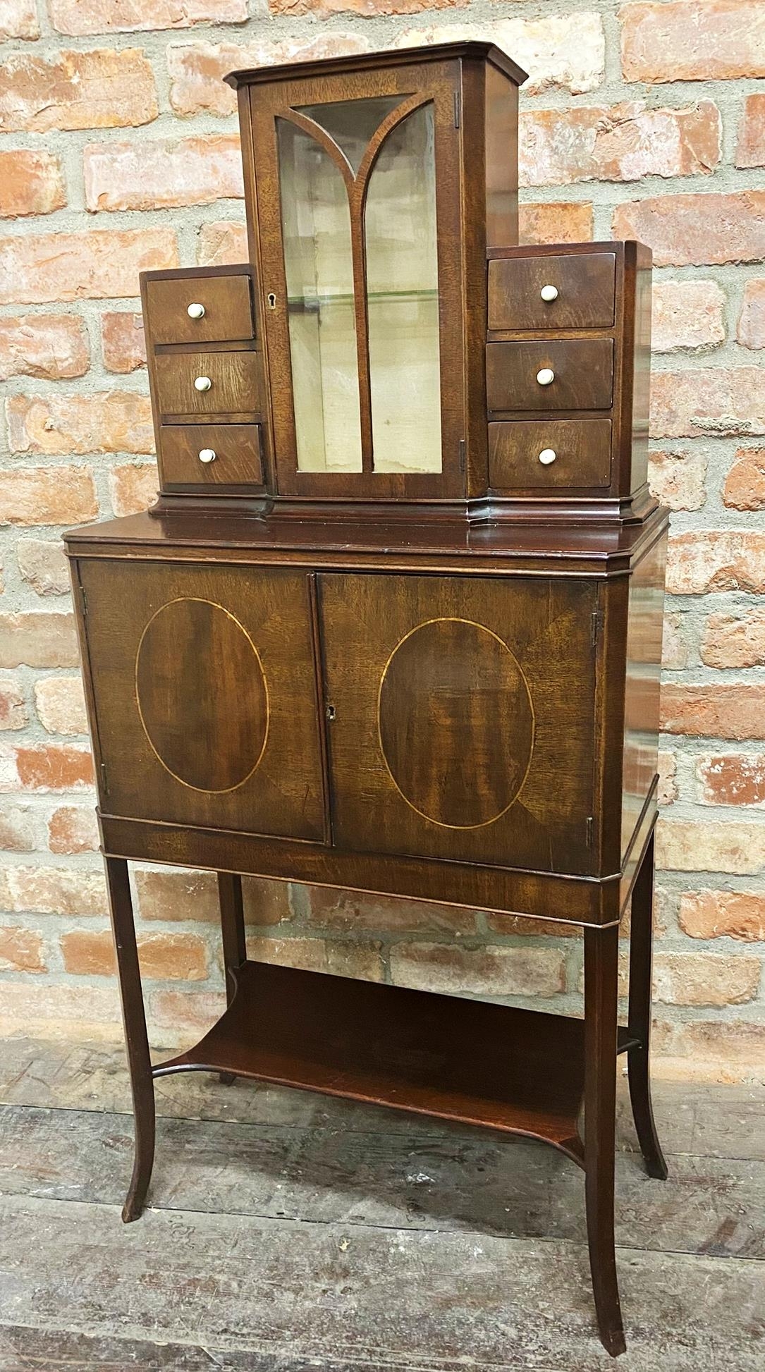 Good early 20th century exhibition quality cabinet, raised glazed back flanked by six small drawers,