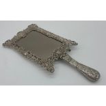 Remarkable late Victorian silver hand / easel mirror, the frame pierced with hinged handle,