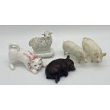 A pair of Beswick pigs together with a resin study of a reclining pig, a Staffordshire study of a