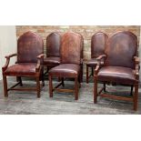 Set of eight ox blood leather stuffover dining chairs with studded upholstery to include two carvers