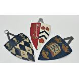 Three hand painted sheet metal wall hanging shields with polychrome decoration, 28cm (3)