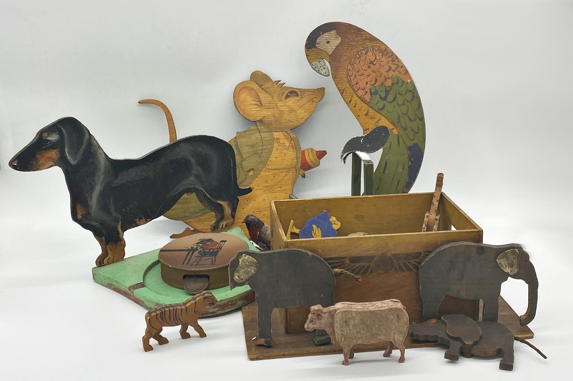 Collection of wooden cut-out playful vintage characters to include a pot stand mounted by a