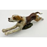 Cold painted bronze study of a leaping beagle, upon a hinged base, 21cm x 8cm high