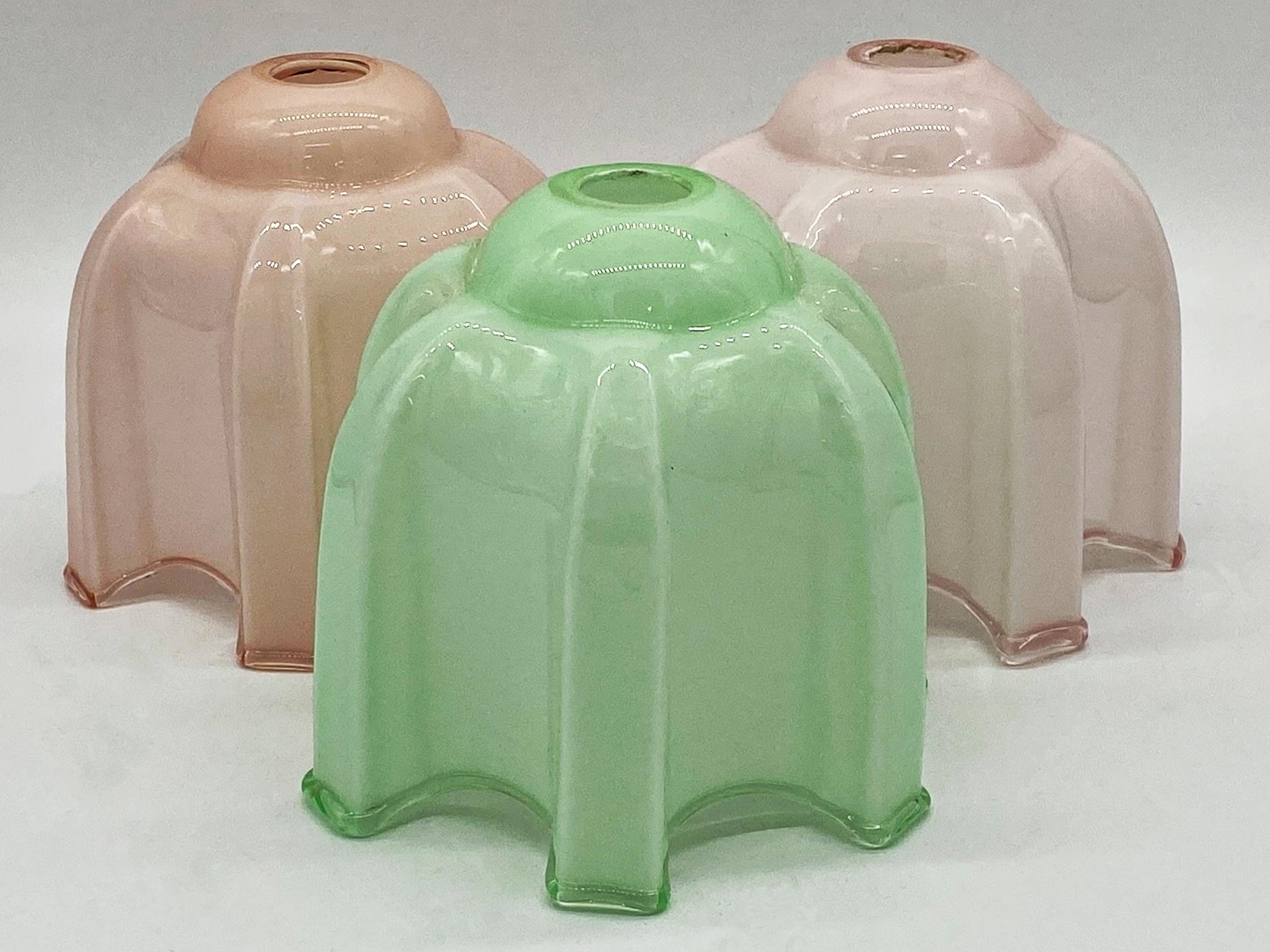 1950's opaline glass shades, two in pink the other in green, 17cm high (3)