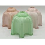 1950's opaline glass shades, two in pink the other in green, 17cm high (3)