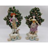 Pair of Chelsea style gold anchor bocage porcelain figures of a standing gentleman and his