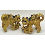 Unusual pair of Chinese pottery Dogs of Fo in famille jaune playing with their young, with blue