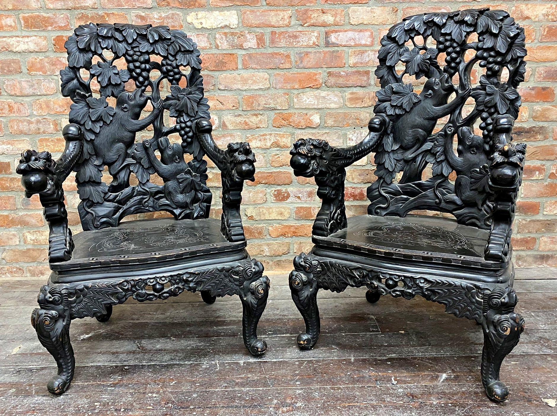 Pair of early 20th century Chinese ebonised carved thrones, the back panel pierced with monkeys