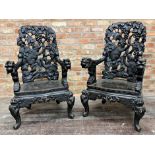 Pair of early 20th century Chinese ebonised carved thrones, the back panel pierced with monkeys