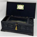 Late 19th century Swiss carved music box, the lid carved with lyre and scrolled foliage in a darted