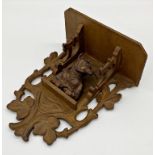 Black Forest carved boxwood wall bracket with lacquered finish, carved with a humorous fox wearing