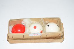 Cardboard case containing three billiard balls