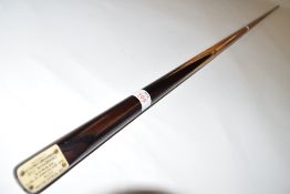 Cue with a badge for Tom Newman, with insert 'made with facsimile of Newman Champion cue World