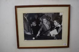 Black and white photographic print, Queen Mother playing snooker, f/g, 55cm wide