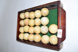 Baize lined box containing 22 ivory billiard balls