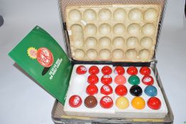 A case containing a set of KitKat promotional snooker balls together with a programme for the KitKat