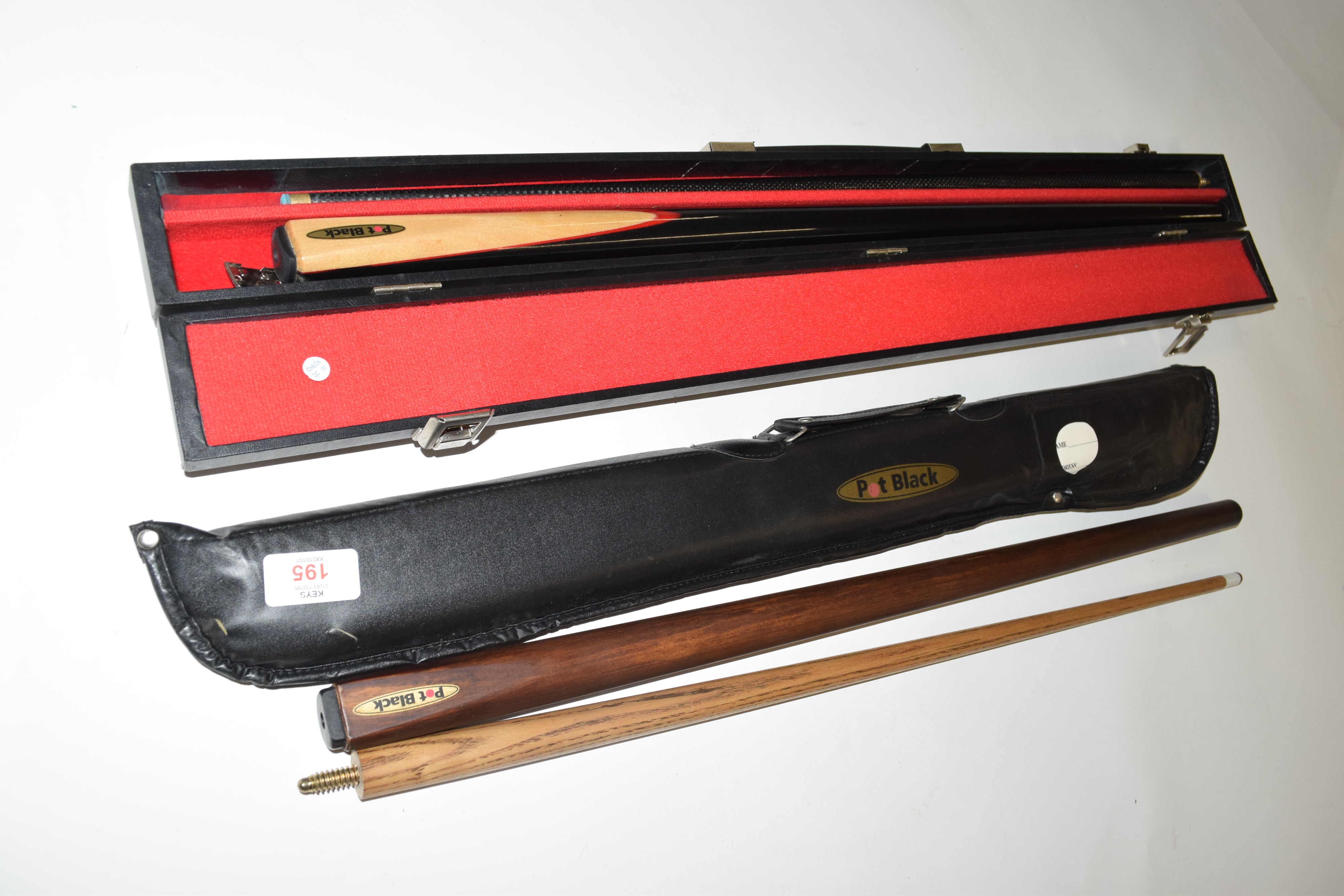 A Pot Black two-piece cue in hard travel case together with another similar in padded travel case (