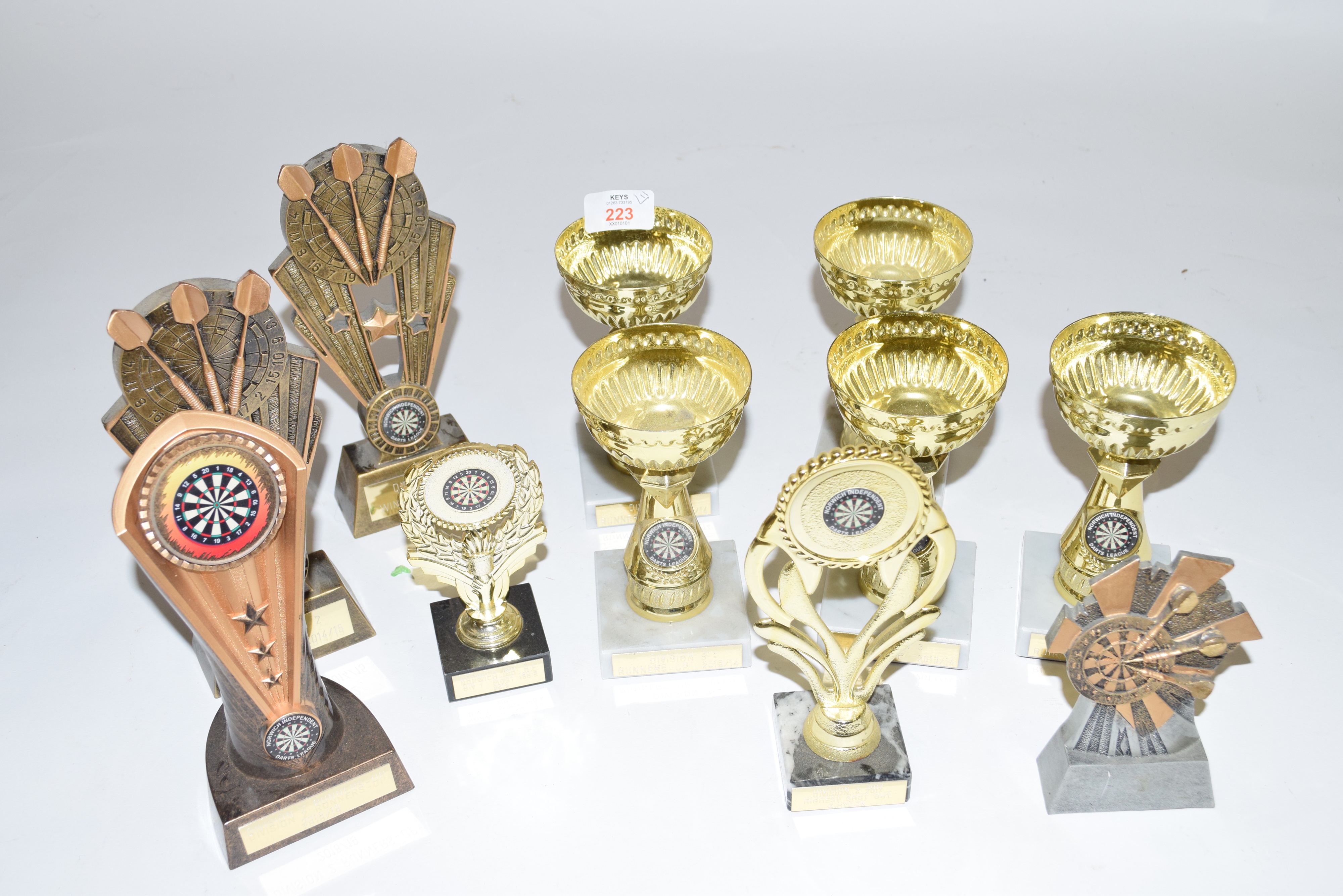 Group of eleven various small darts trophies, plastic/composition construction