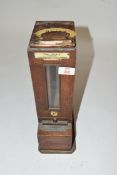 Vintage oak cased penny operated chalk dispenser marked 'The Dorie Improved', 37cm high (a/f)