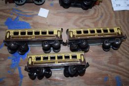 Three 0 gauge metal carriages stamped 'Made in England'