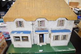 Early 20th century Triange 'Princess House' dolls house with hinged front and pebbledashed finish.