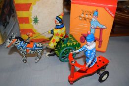 Miniature metal clockwork clown on a horse carriage, together with a further clockwork model of a