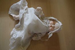 Late 19th/early 20th century porcelain double-faced doll with white gown and cap, no maker's marks