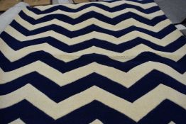 Dark blue/ivory floor rug, approx 150cm wide