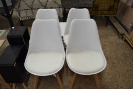 Four white dining chairs