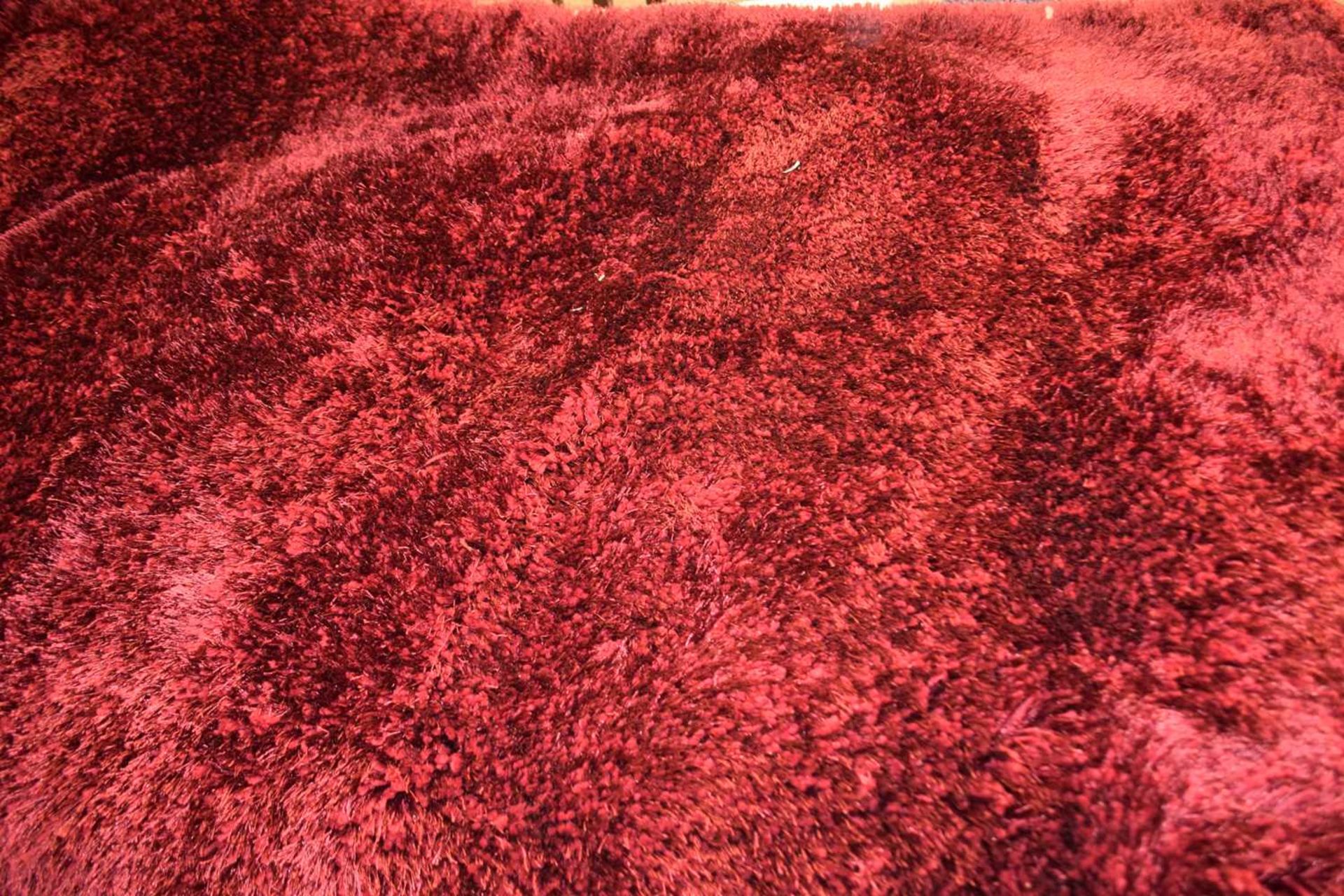 France hand made dark red shaggy rug, width approx 150cm