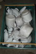 Crate containing a quantity of teapots and milk jugs