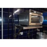 Buffalo commercial microwave oven together with a stainless steel shelf