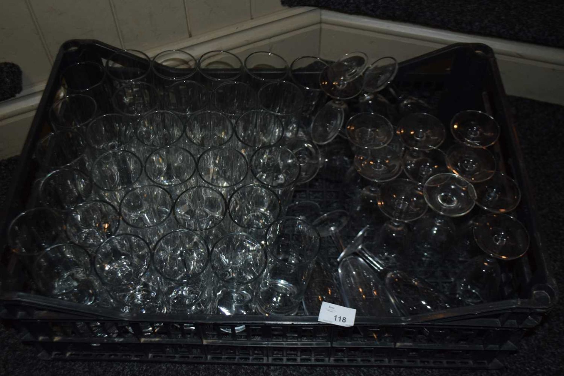 Crate containing mixed glass ware to include high ball glasses and wine glasses