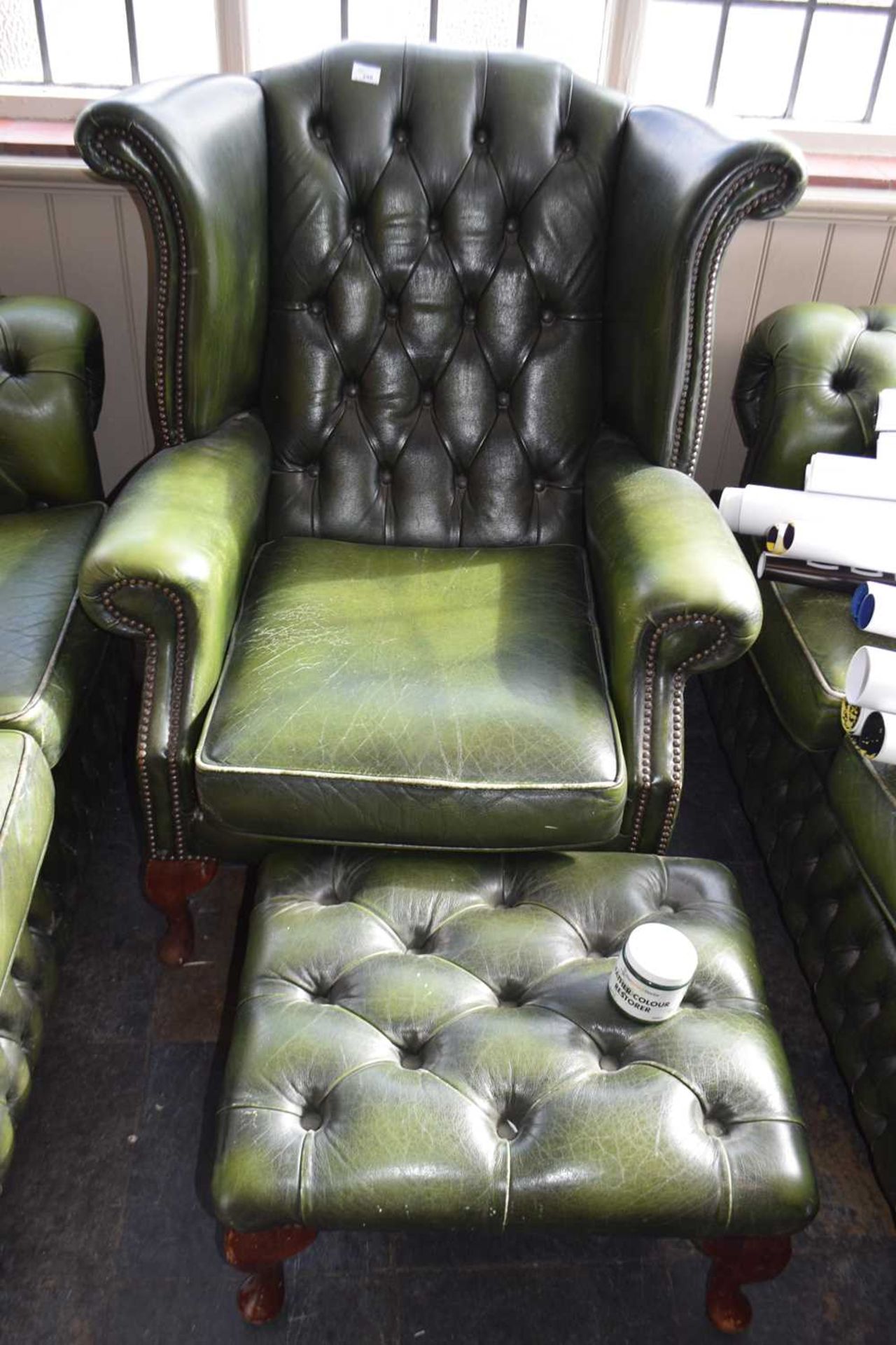 Chesterfield style leather armchair with matching foot stool