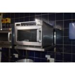 Buffalo GK640 microwave oven together with a stainless steel shelf