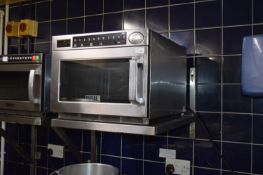 Buffalo GK640 microwave oven together with a stainless steel shelf